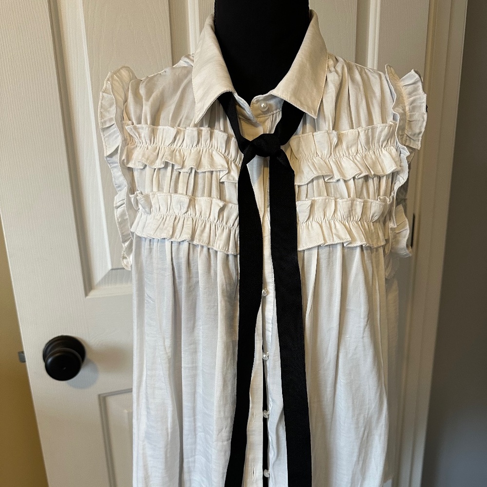Women’s medium white ruffle sleeveless blouse with black ribbon detail
